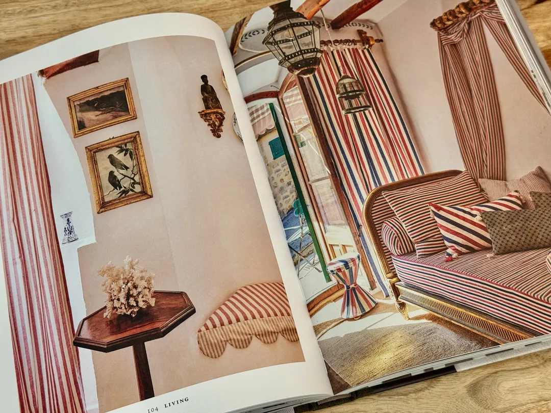 Bedroom with a striped canopy and a pink striped daybed