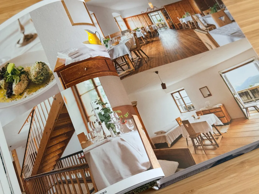 Sunlit hotel dining room and wooden staircase