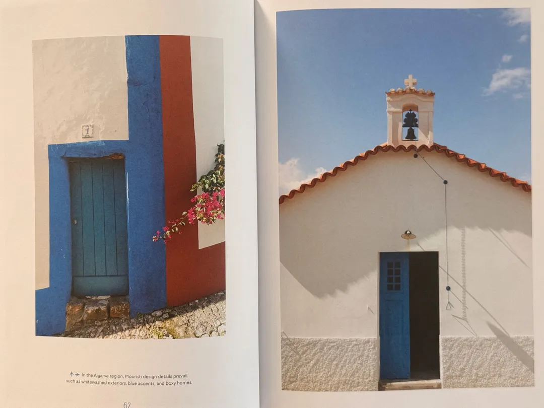 Whitewashed walls with cobalt-blue door frames and a small bell-tower chapel
