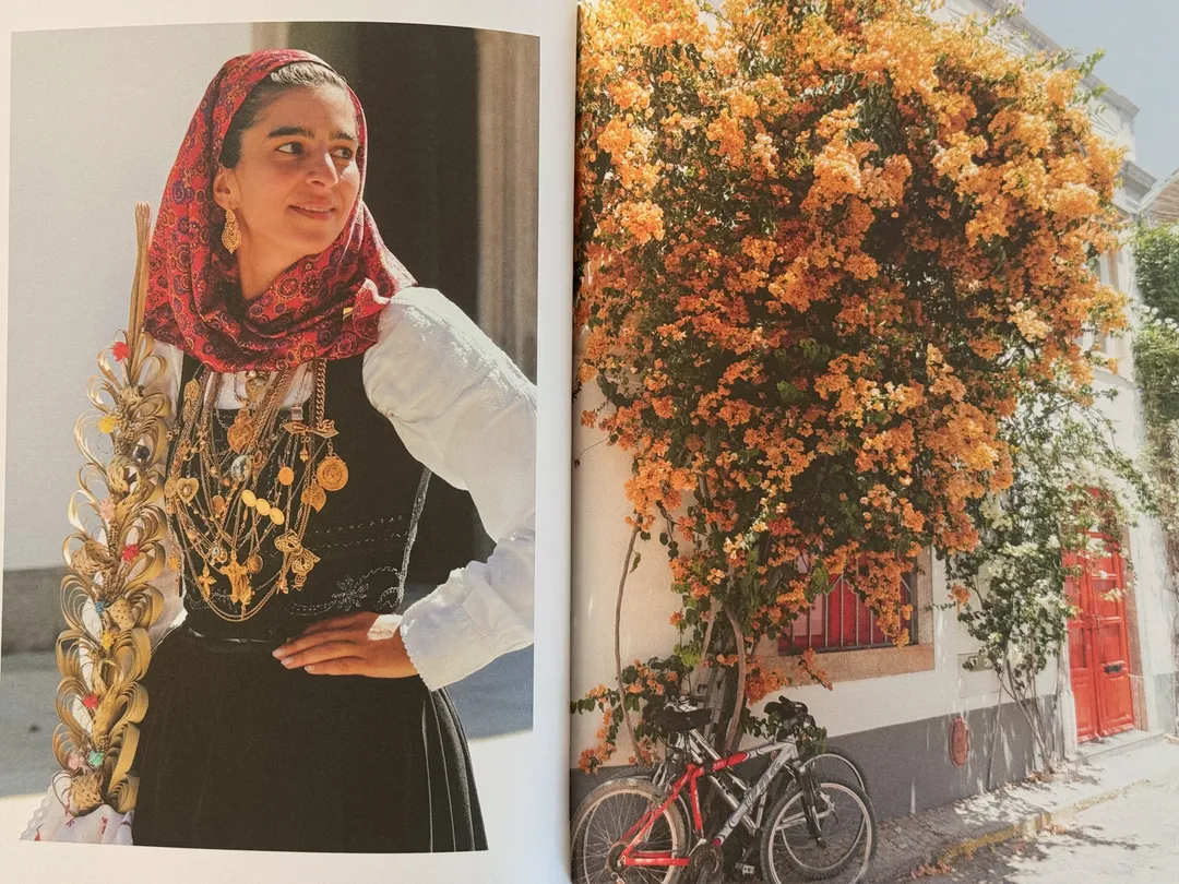 Woman in traditional dress and gold filigree jewellery beside orange bougainvillea