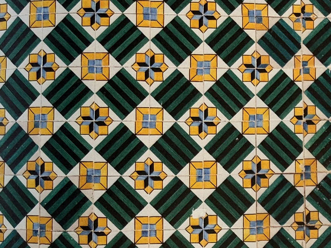 Close-up of green, yellow and blue geometric azulejo tiles