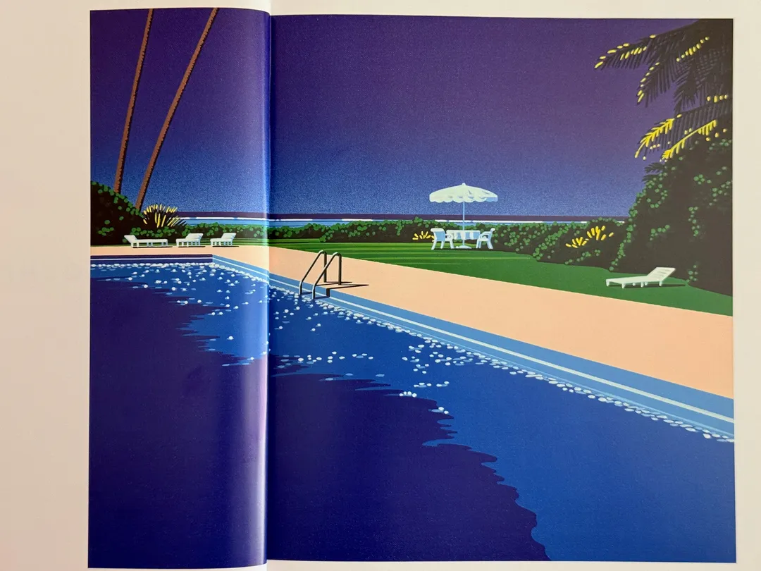 Painted pool deck with a white umbrella and tropical trees