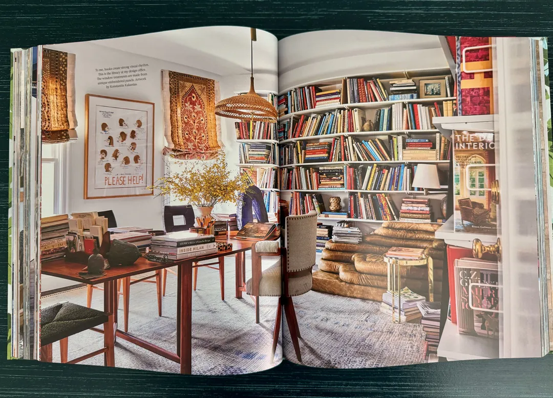 Book-lined study with a wooden desk and patterned rugs