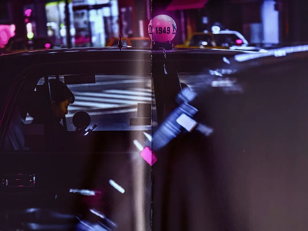 Taxi in the rain with a glowing pink lantern